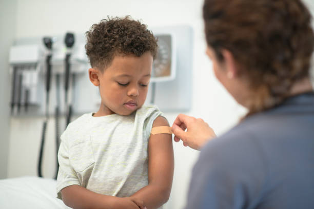 istock Boy receives bandaid from his nurse 1175995295
