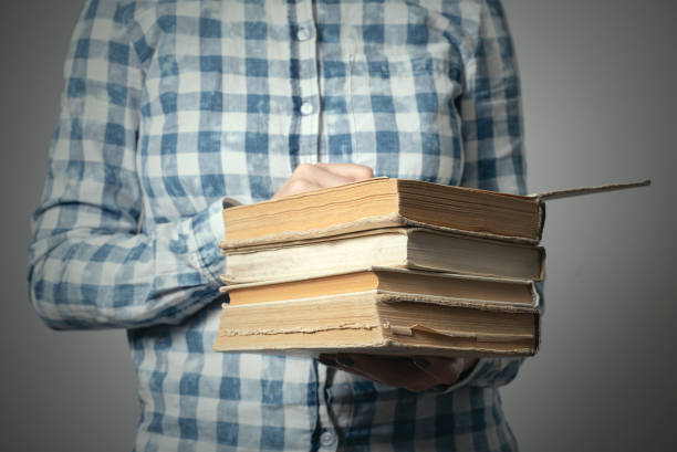 istock Stack of books in female hands. 1175997845