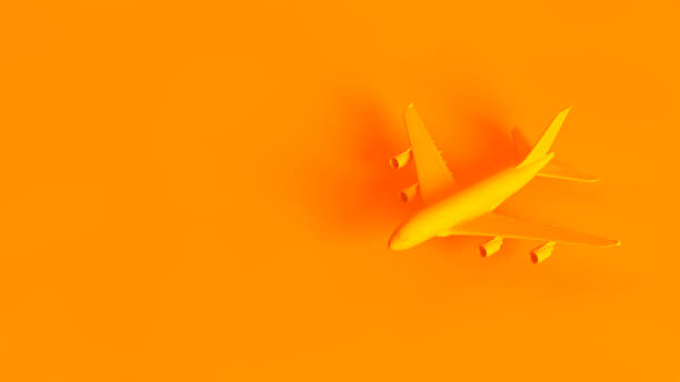 Air travel concept image. Passenger jet airplane isolated on orange background.