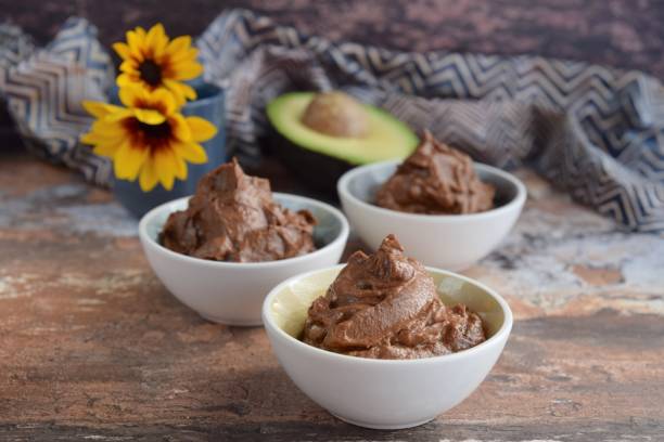 istock Raw organic avocado chocolate pudding or mousse. Decorated with sunflowers 1175999988