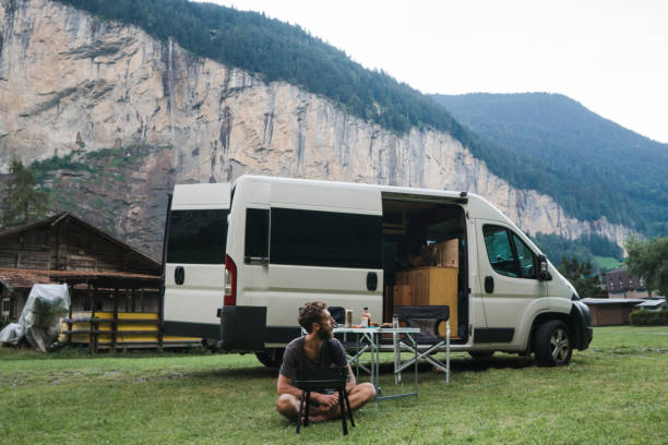 istock Man grilling burger in camping in Swiss Alps 1176000115
