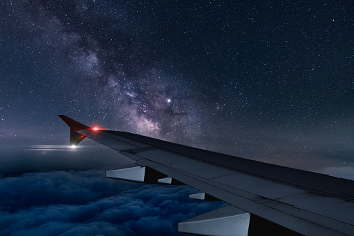 View of milky way from plane window while flying at night