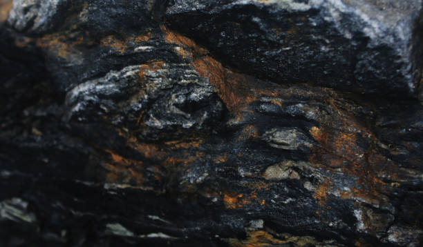 istock A blueish black stone with a lot of rust in the pockets 1176010275