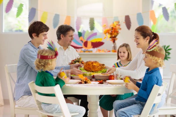 istock Family with kids at Thanksgiving dinner. Turkey. 1176010794
