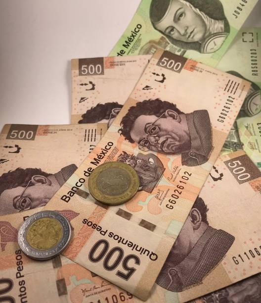 istock A group of mexican peso bills isolated on white background 1176010878