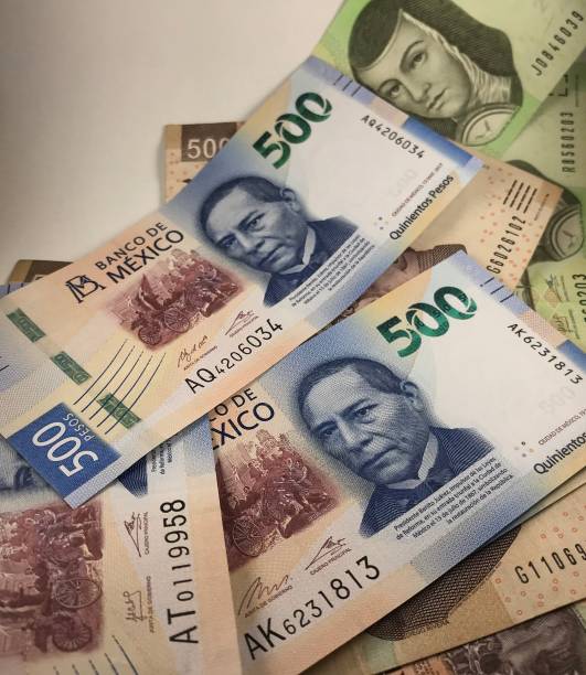 istock A group of mexican peso bills isolated on white background 1176012354