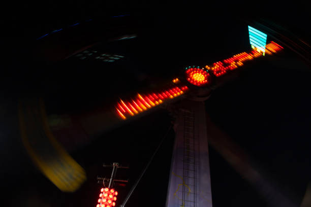 Towers of light and colored spotlightsin pendular movement in Fair that gives nightlife to San Nicolas Tlazala MexicoLight trails drawn by pendulum movement at  Fair in Mexico night life