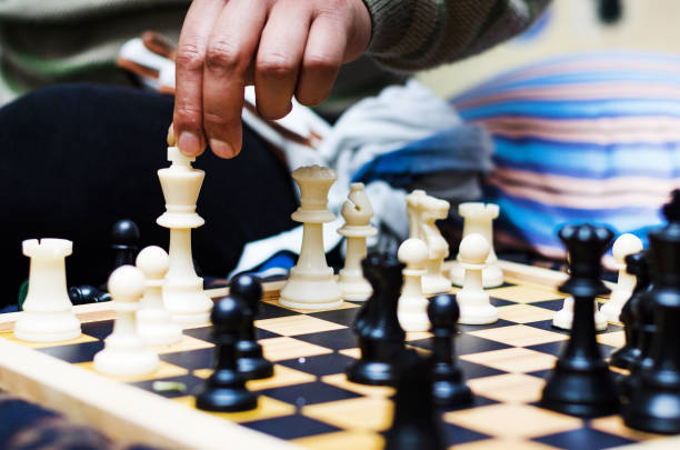 istock White chess king alone surrounded by the opposite pieces, selective focus on white chess king piece 1176020790