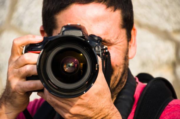 istock Photographer, taking photos with his professional camera 1176021515