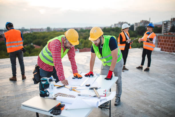 istock Team of architects and construction workers revising blueprints 1176022704