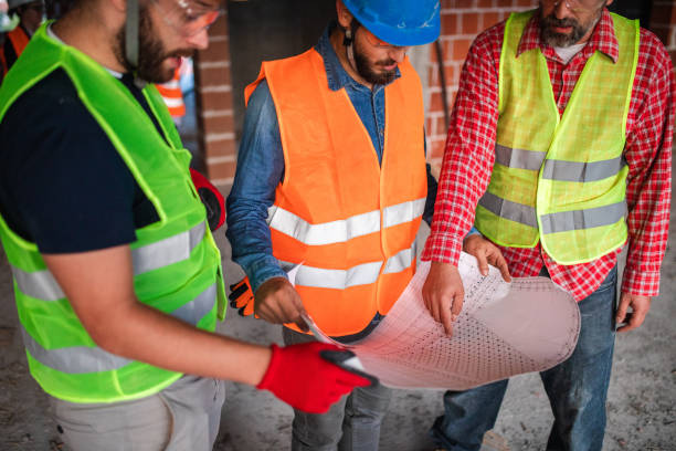 istock Reviewing blueprint together 1176023409