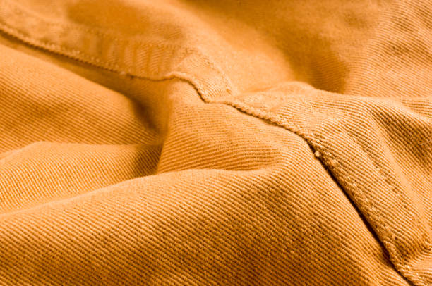 istock clothing items stonewashed cotton fabric texture with seams, clasps, buttons and rivets, macro 1176023580