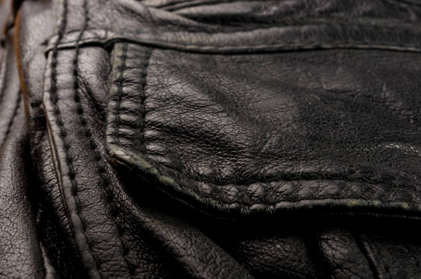 istock Old vintage genuine soft black leather texture background, top layer with pores and scratches, macro, close-up 1176024734