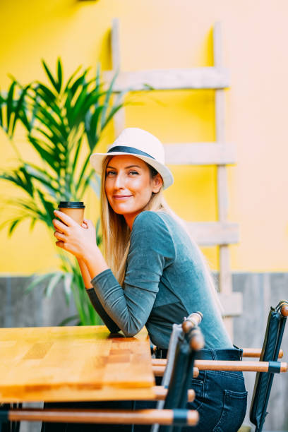 istock Beautiful Blond Woman Drinking Coffee in Cardboard Cup 1176028657