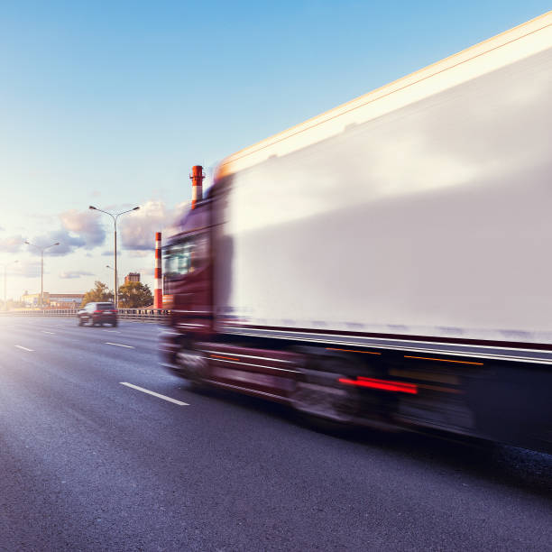 istock Freight truck moves fast on the highway at sunset time. 1176031427