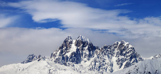 istock Mounts Ushba and Chatyn and blue sky with clouds 1176032566