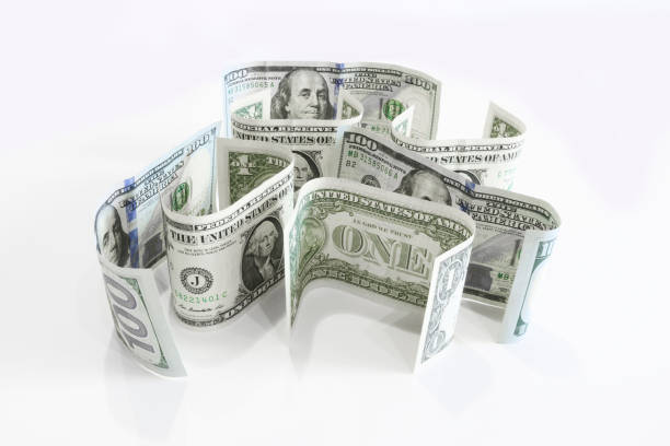 istock American currency - one-dollar and hundred-dollar bills stand on a surface. 1176032635