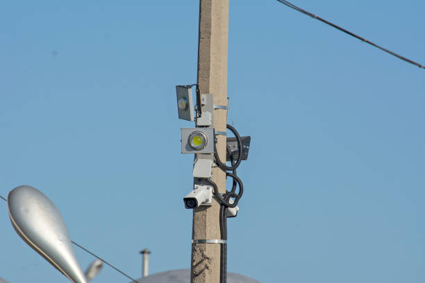 istock Street surveillance camera mounted on a pole with LED spotlights 1176039218