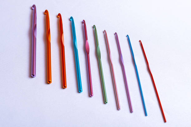 istock Crochet hooks of different sizes and colors arranged in one row, rainbow palette 1176042708