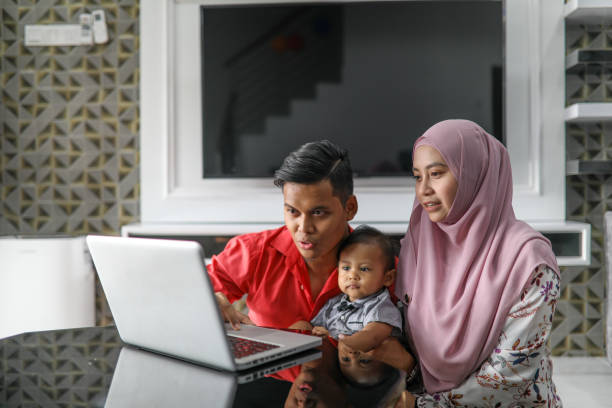 istock Beautiful family using laptop at home 1176042865