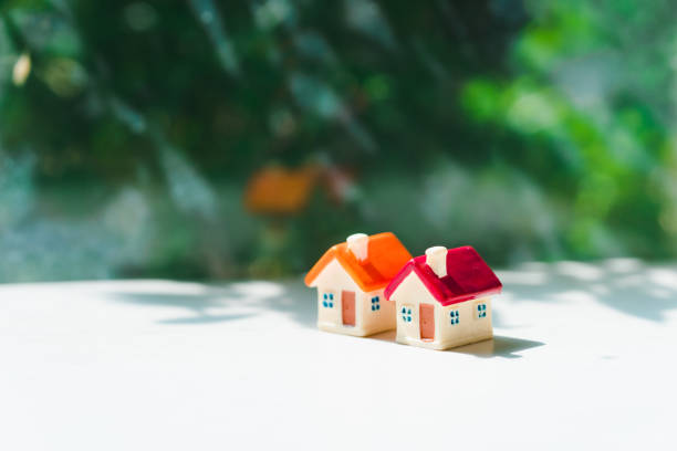 istock Closeup miniature house on green nature background 1176042939