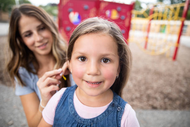 istock Mom is Fixing Her Daughter's Hair 1176044772