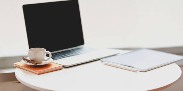 istock Minimal workplace with open laptop, coffee cup and office supplies 1176048566