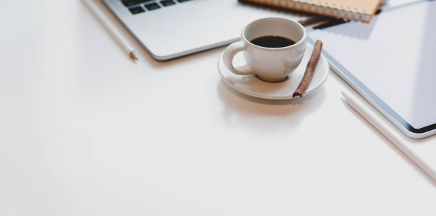 istock Minimal workplace with open laptop, coffee cup and office supplies 1176048573