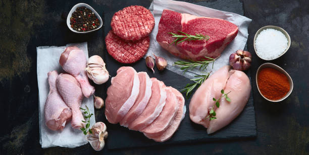 istock Raw meat assortment on black background. 1176053332