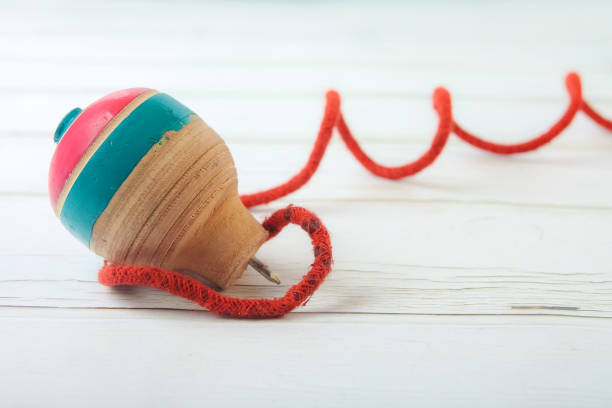 istock Classic wooden spinning top toy with string 1176054017