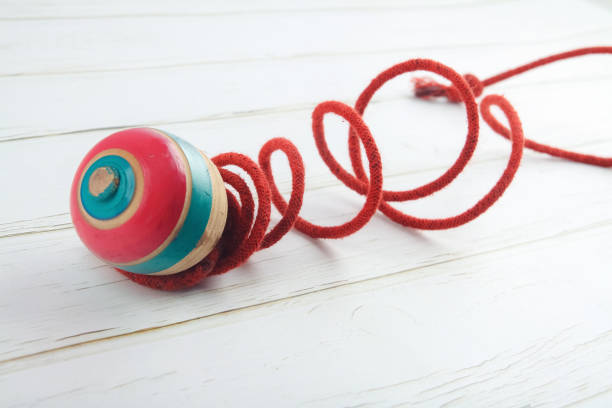 istock Classic wooden spinning top toy with string 1176054026