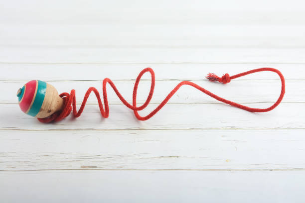 Classic wooden spinning top toy with string