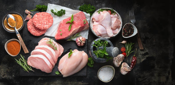 istock Raw meat assortment on black background. 1176054042