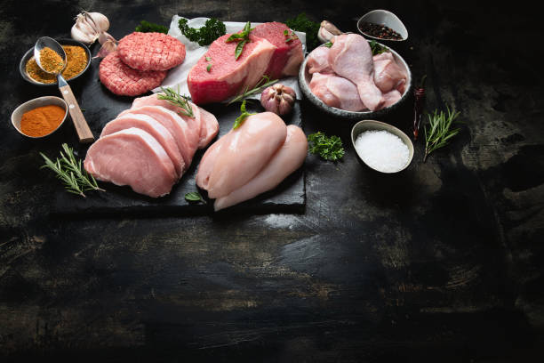 istock Raw meat assortment on black background. 1176054138
