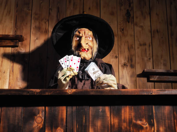 istock Witch and casino. wooden background. Halloween concept. 1176054621