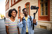 Young smiling youtubers saying hello.