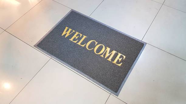istock Front door with doormat plants with welcome written on it 1176057584