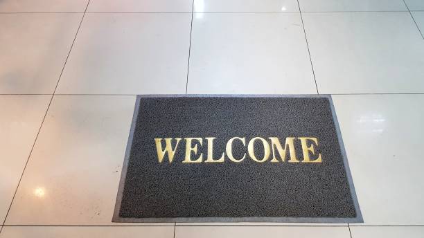 istock Front door with doormat plants with welcome written on it 1176057602