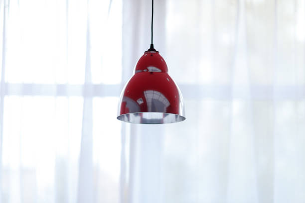 istock lampshades hanging from the ceiling, shot against a window 1176064299