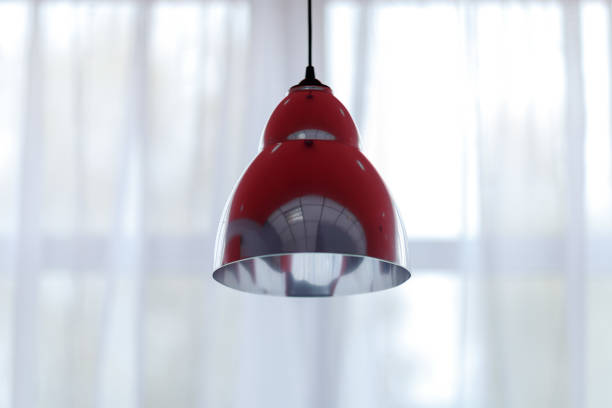 istock lampshades hanging from the ceiling, shot against a window 1176064306