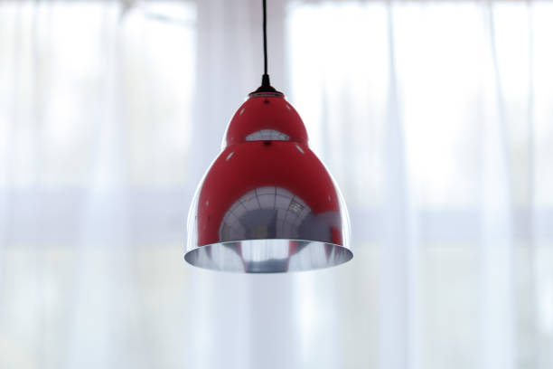 istock lampshades hanging from the ceiling, shot against a window 1176064312