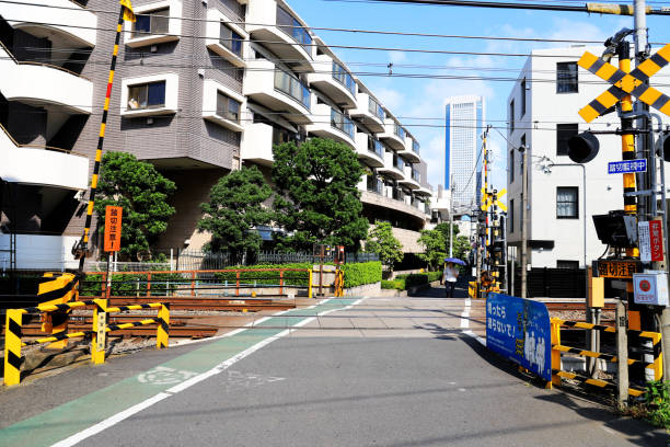 Railroad crossing (crossing) and boom barrier (circuit breaker) at Odakyu Odawara Line Sangubashi Station (Odakyu Electric Railway Odawara Line Samiyabashi Station) stock photo
