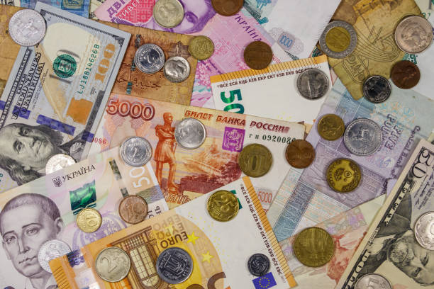 istock Background of banknotes and coins from different countries 1176075593