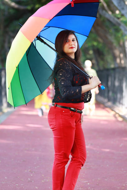 istock Young women under colorful umbrella 1176077371