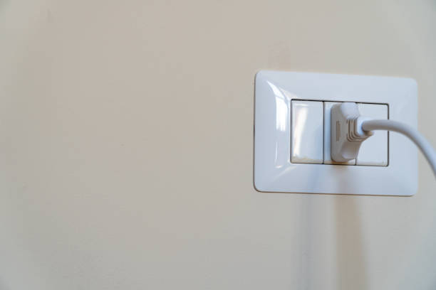 istock white cable plugged in a italian white electric outlet mounted on wall 1176078088