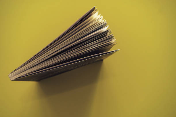 istock Beautiful book top view on a yellow background table. 1176079035