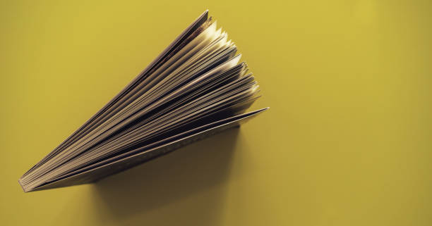 istock Beautiful book top view on a yellow background table. 1176079044