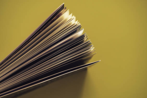 istock Beautiful book top view on a yellow background table. 1176079078