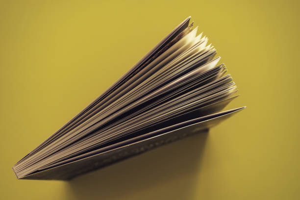 istock Beautiful book top view on a yellow background table. 1176079095