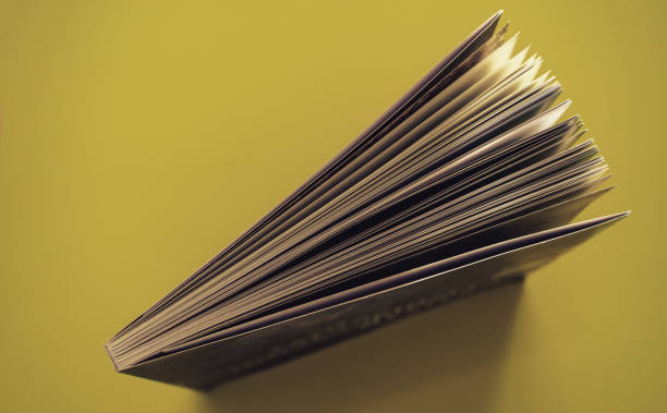 istock Beautiful book top view on a yellow background table. 1176079118